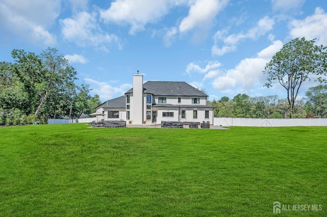 36 School Rd E, Marlboro, NJ 07746 - back of property featuring a patio area, a chimney, a fenced backyard, and stucco siding