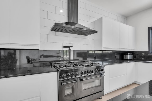 36 School Rd E, Marlboro, NJ 07746 - kitchen with wall chimney exhaust hood, range with two ovens, decorative backsplash, and white cabinetry