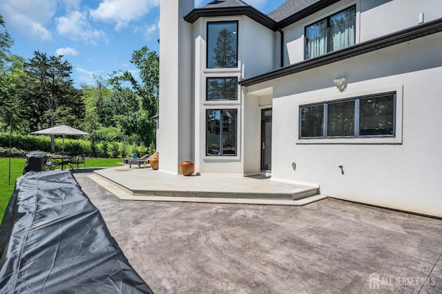 36 School Rd E, Marlboro, NJ 07746 - rear view of house with a patio and stucco siding