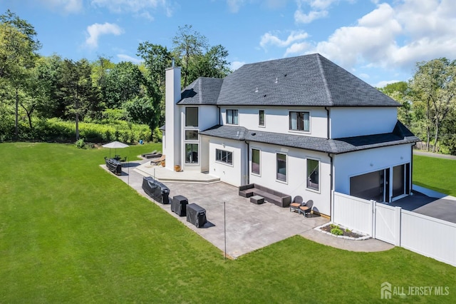 36 School Rd E, Marlboro, NJ 07746 - back of house with a chimney, stucco siding, a patio area, asphalt driveway, and a garage