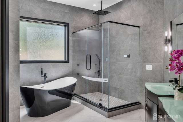 36 School Rd E, Marlboro, NJ 07746 - bathroom with tile walls, a stall shower, a soaking tub, vanity, and tile patterned flooring