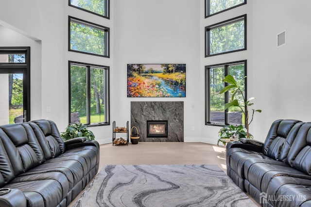 36 School Rd E, Marlboro, NJ 07746 - living area featuring a high ceiling, wood finished floors, healthy amount of natural light, and a fireplace