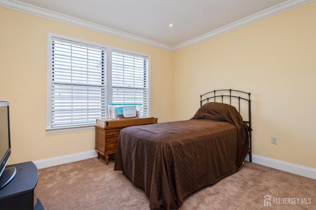 bedroom with crown molding, baseboards, and light carpet