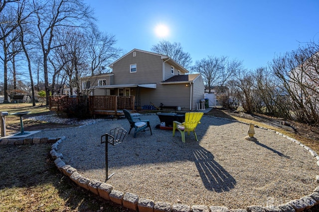 rear view of house featuring a wooden deck