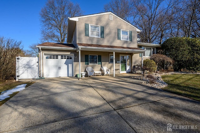 view of front of home featuring covered porch and a garage