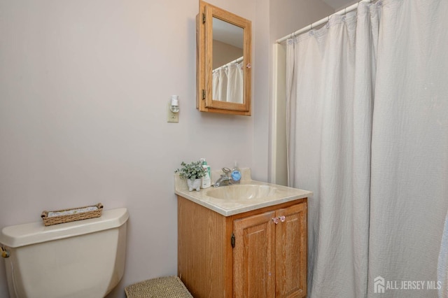 bathroom featuring toilet and vanity