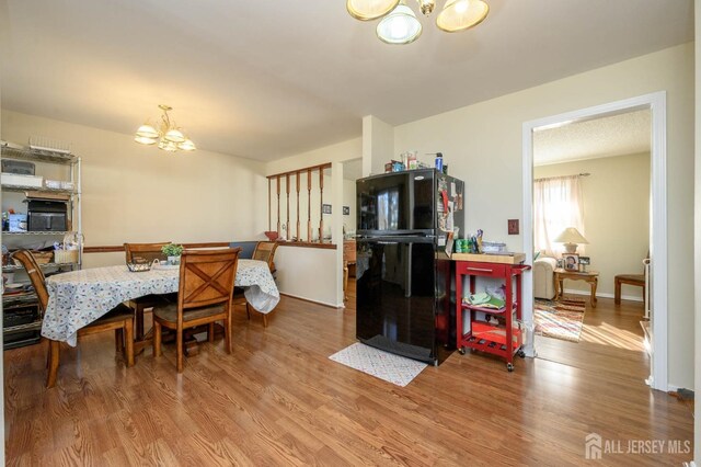 dining room featuring a chandelier and hardwood / wood-style flooring