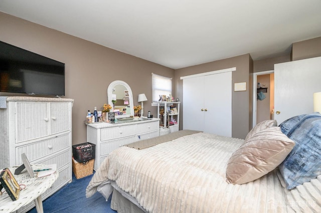 carpeted bedroom featuring a closet