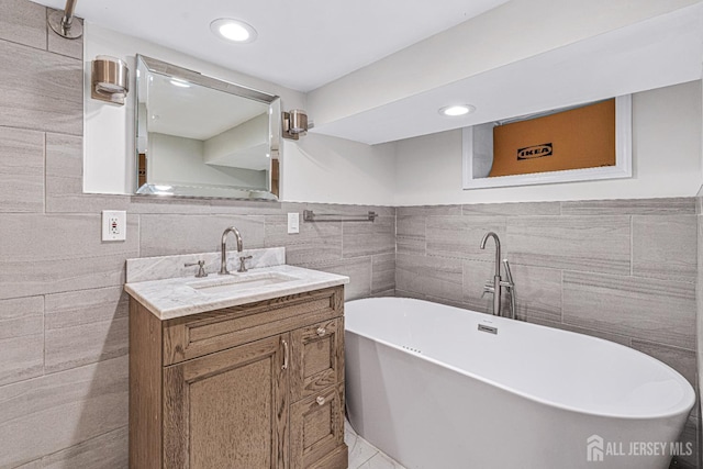 425 Grove Ave, Metuchen, NJ 08840 - bathroom featuring tile walls, a freestanding bath, vanity, recessed lighting, and a wainscoted wall