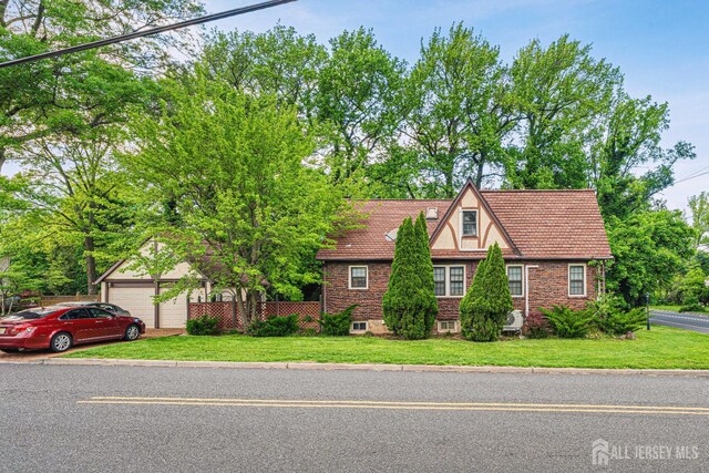 425 Grove Ave, Metuchen, NJ 08840 - tudor-style house with a garage
