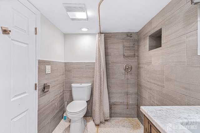 425 Grove Ave, Metuchen, NJ 08840 - bathroom featuring tiled shower, toilet, tile walls, and vanity