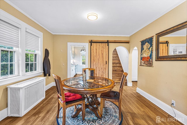 425 Grove Ave, Metuchen, NJ 08840 - dining space featuring radiator, wood finished floors, a barn door, baseboards, and ornamental molding