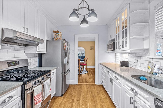 425 Grove Ave, Metuchen, NJ 08840 - kitchen with stainless steel appliances, under cabinet range hood, white cabinets, a chandelier, and light wood-style flooring