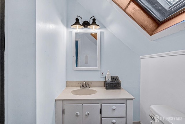 425 Grove Ave, Metuchen, NJ 08840 - bathroom featuring toilet, vanity, a skylight, and lofted ceiling