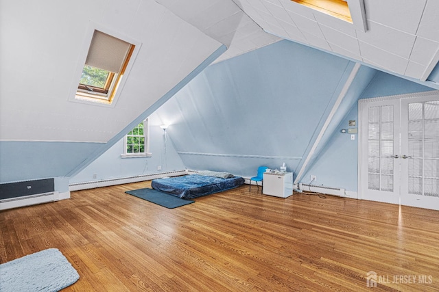 425 Grove Ave, Metuchen, NJ 08840 - unfurnished bedroom featuring wood finished floors, lofted ceiling, a baseboard radiator, and a skylight
