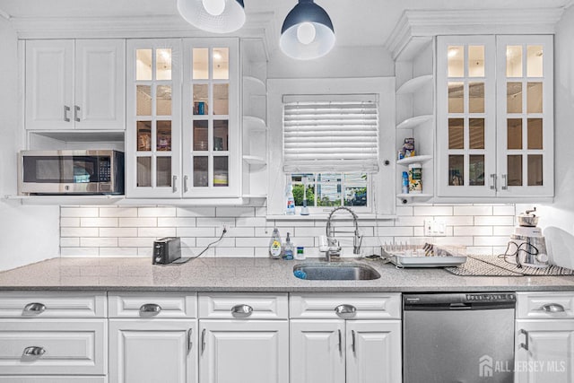 425 Grove Ave, Metuchen, NJ 08840 - kitchen featuring appliances with stainless steel finishes, a sink, white cabinets, and backsplash