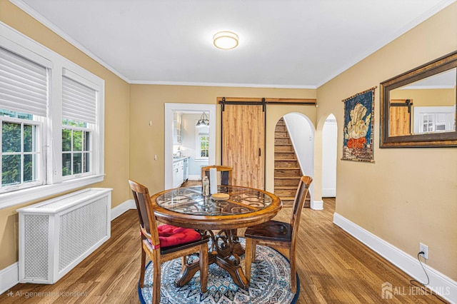 425 Grove Ave, Metuchen, NJ 08840 - dining area featuring radiator, a barn door, wood finished floors, baseboards, and plenty of natural light