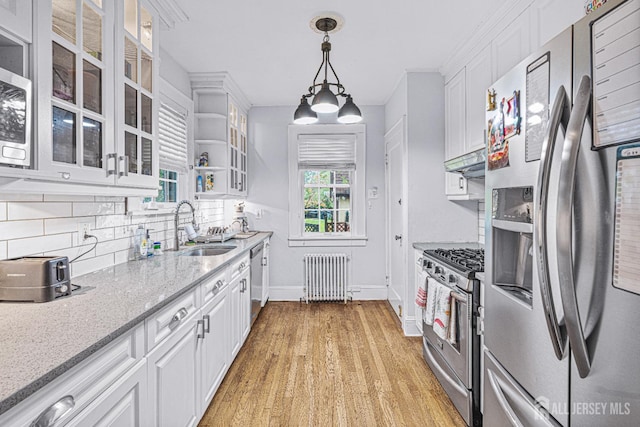 425 Grove Ave, Metuchen, NJ 08840 - kitchen featuring stainless steel appliances, radiator, a sink, white cabinets, and baseboards
