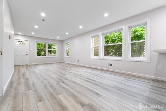 763 Gadek Pl, Perth Amboy, NJ 08861 - unfurnished living room with light wood finished floors, healthy amount of natural light, baseboards, and recessed lighting