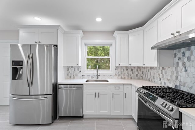 763 Gadek Pl, Perth Amboy, NJ 08861 - kitchen with stainless steel appliances, a sink, under cabinet range hood, white cabinetry, and light countertops