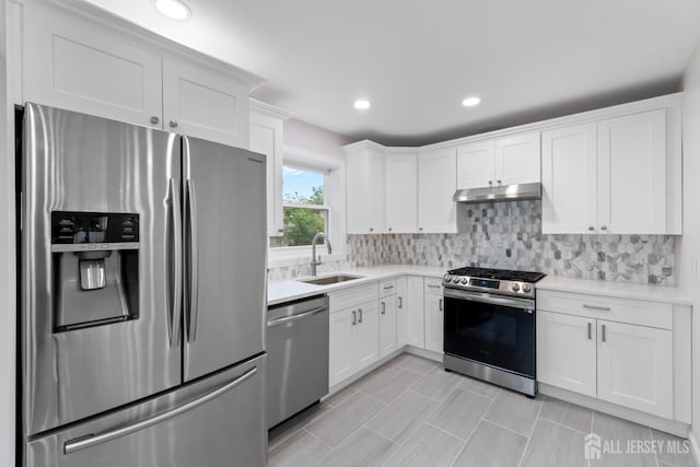 763 Gadek Pl, Perth Amboy, NJ 08861 - kitchen with appliances with stainless steel finishes, a sink, under cabinet range hood, light countertops, and recessed lighting
