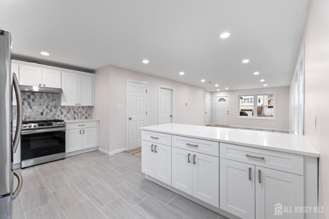 763 Gadek Pl, Perth Amboy, NJ 08861 - kitchen featuring stainless steel appliances, under cabinet range hood, white cabinets, decorative backsplash, and recessed lighting