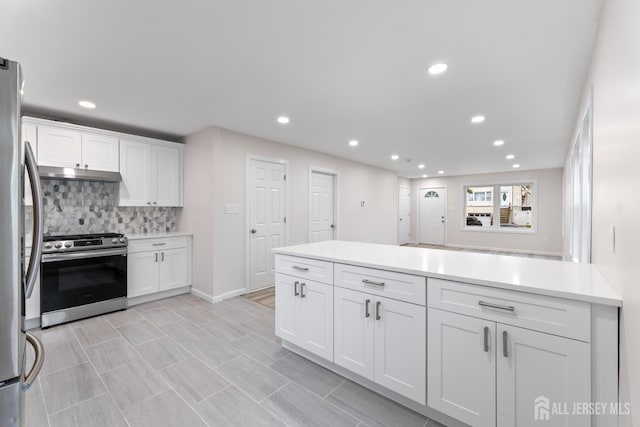 763 Gadek Pl, Perth Amboy, NJ 08861 - kitchen featuring appliances with stainless steel finishes, under cabinet range hood, white cabinets, backsplash, and recessed lighting