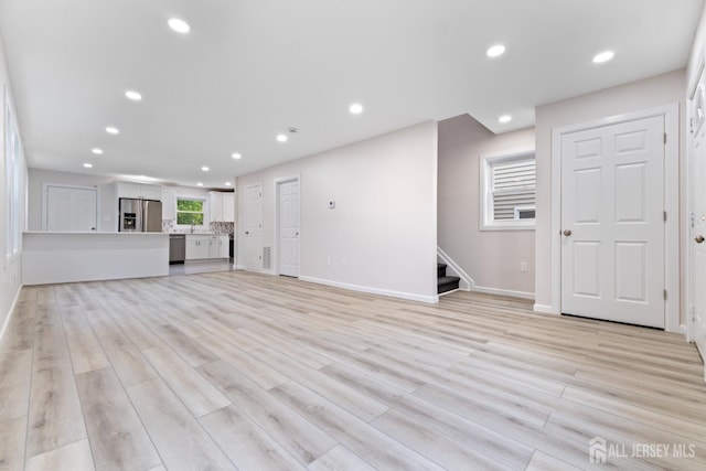 763 Gadek Pl, Perth Amboy, NJ 08861 - unfurnished living room featuring baseboards, stairway, light wood-type flooring, and recessed lighting