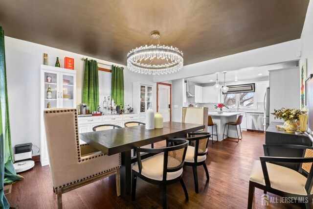 dining area featuring dark hardwood / wood-style flooring and a chandelier