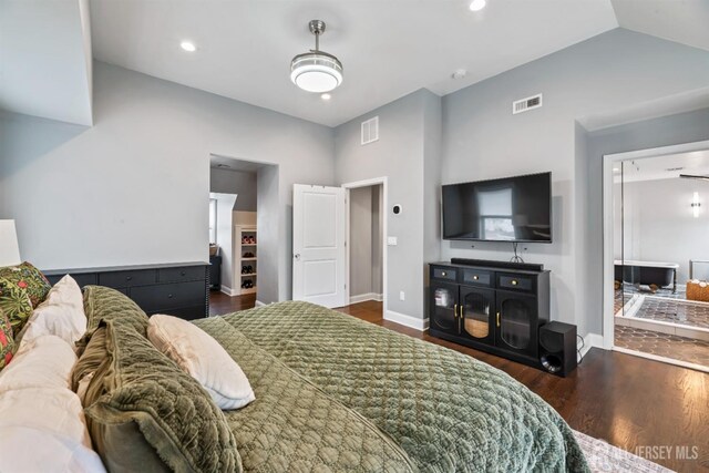 bedroom with dark hardwood / wood-style flooring and lofted ceiling