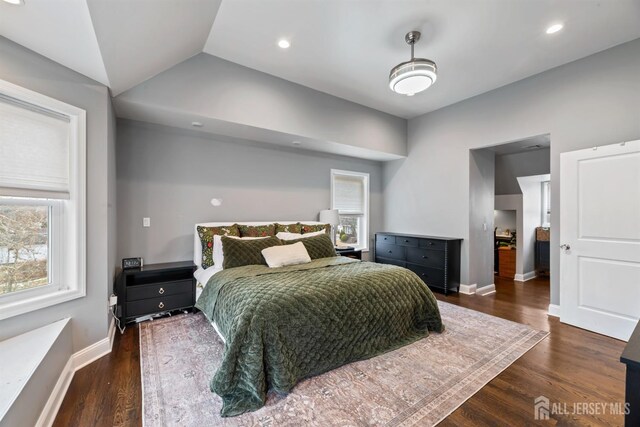 bedroom with vaulted ceiling and dark hardwood / wood-style floors