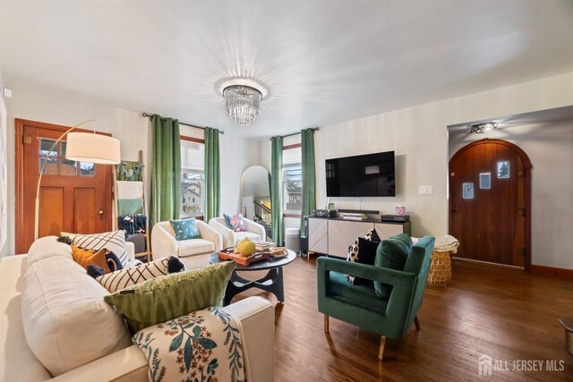 living room featuring a chandelier and hardwood / wood-style flooring