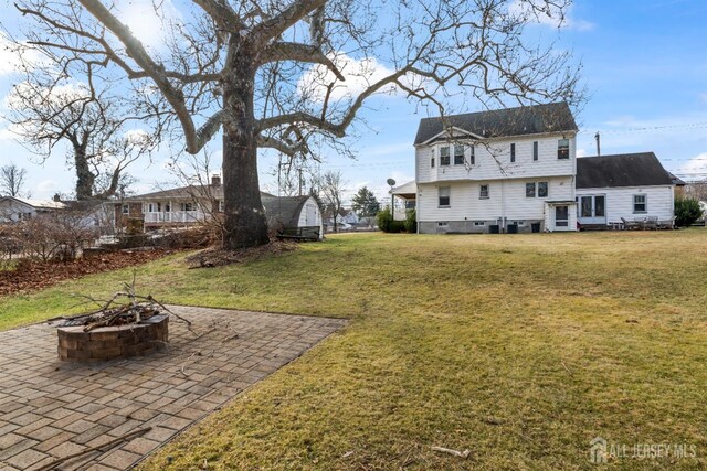 view of yard with a fire pit and a patio area