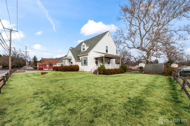 view of home's exterior featuring a yard and covered porch