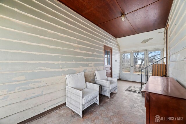 living area with wooden ceiling and lofted ceiling