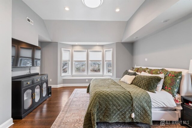 bedroom featuring lofted ceiling and dark hardwood / wood-style floors