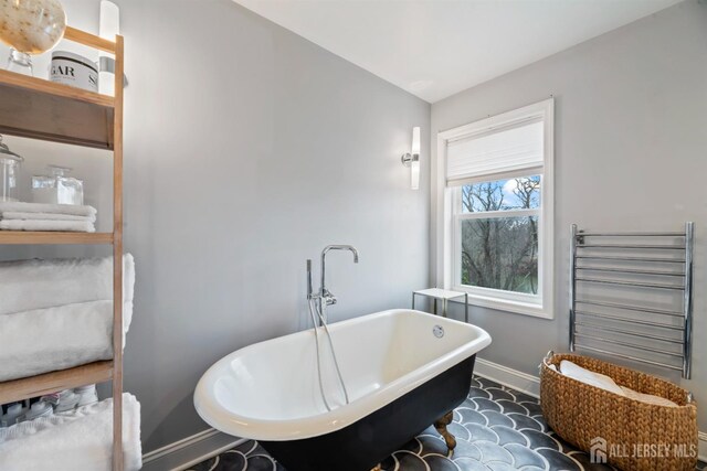 bathroom with radiator and a bathtub