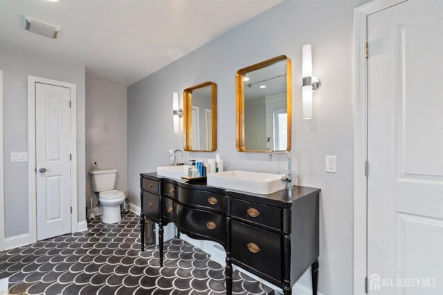 bathroom with toilet and vanity