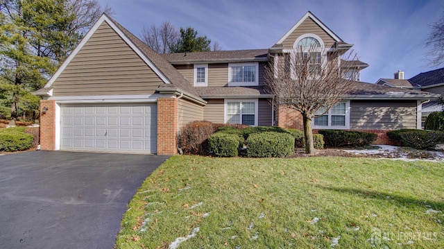 front of property with a garage and a front lawn