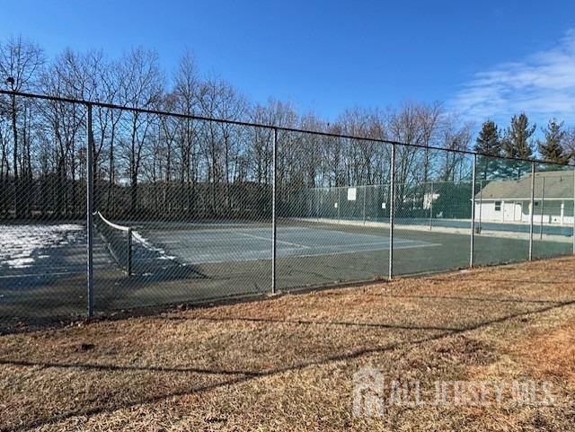 view of sport court featuring fence