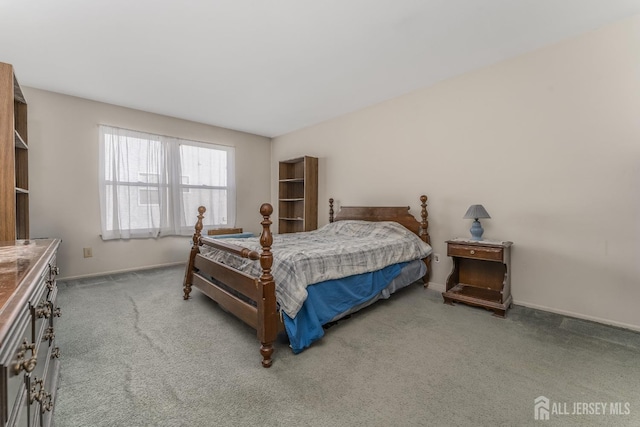 carpeted bedroom featuring baseboards