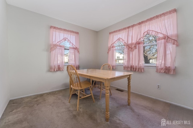 dining room with carpet, visible vents, and baseboards