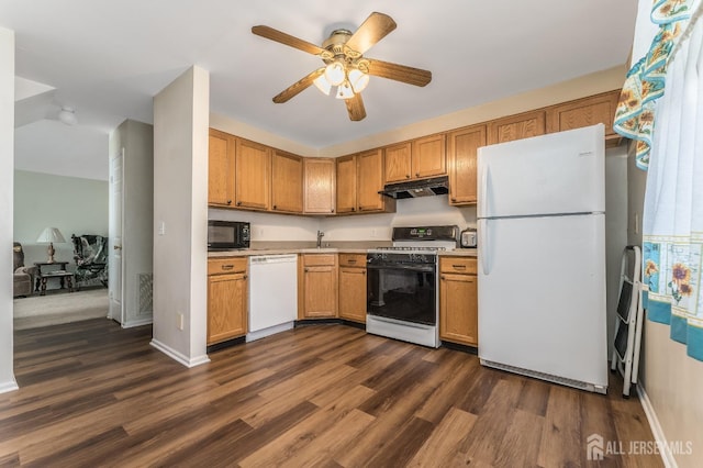 kitchen featuring dark wood-style floors, light countertops, white appliances, and under cabinet range hood