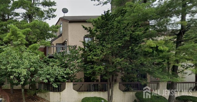 view of home's exterior featuring fence and stucco siding