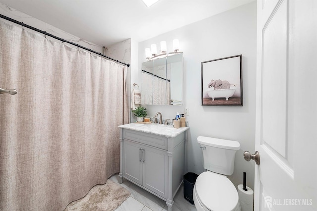 bathroom with vanity, toilet, and tile patterned flooring