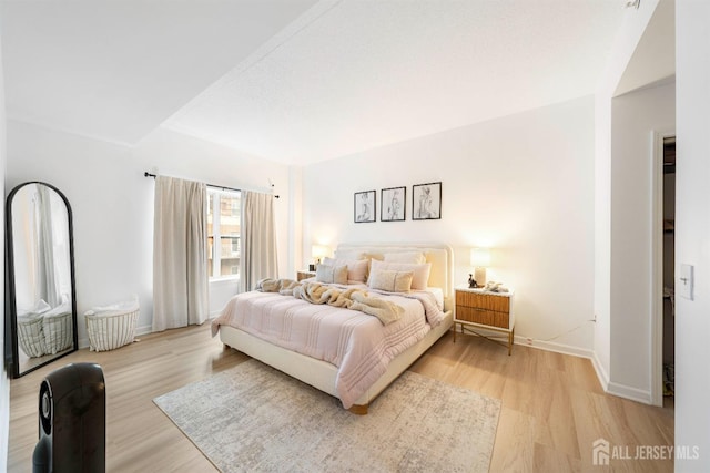 bedroom with light wood-style floors and baseboards