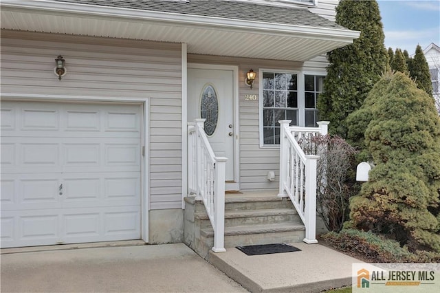 property entrance featuring a garage and a shingled roof