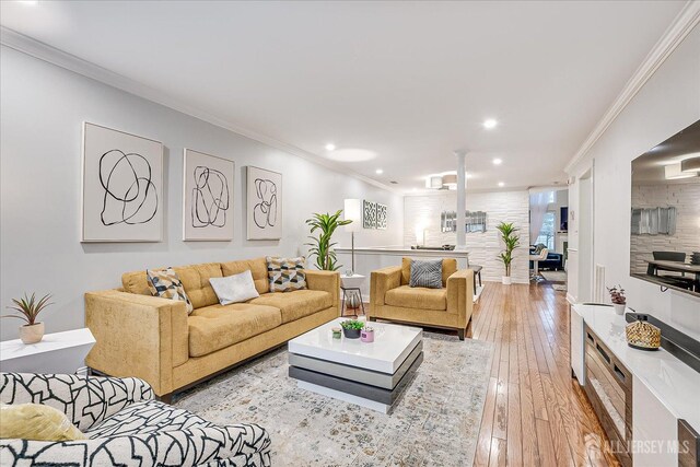 living room featuring light hardwood / wood-style flooring and crown molding