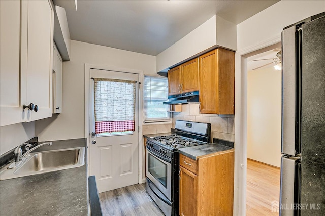 8 Macarthur Dr, Edison, NJ 08837 - kitchen with gas stove, a sink, under cabinet range hood, freestanding refrigerator, and light wood-style flooring