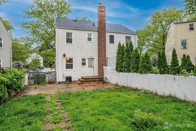 8 Macarthur Dr, Edison, NJ 08837 - back of house featuring a fenced backyard, a chimney, cooling unit, and a shingled roof